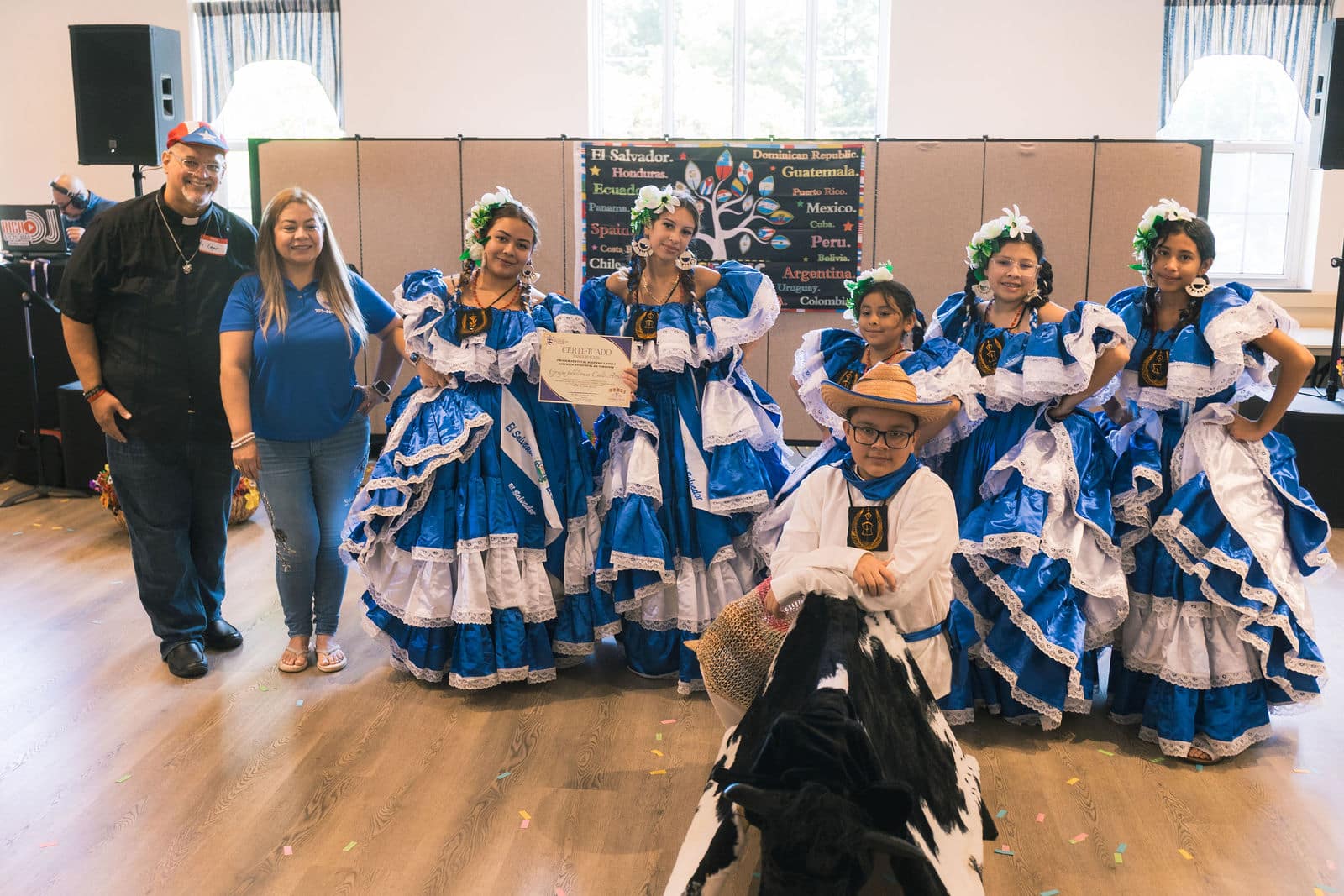 Performers posing together in blue and white costumes
