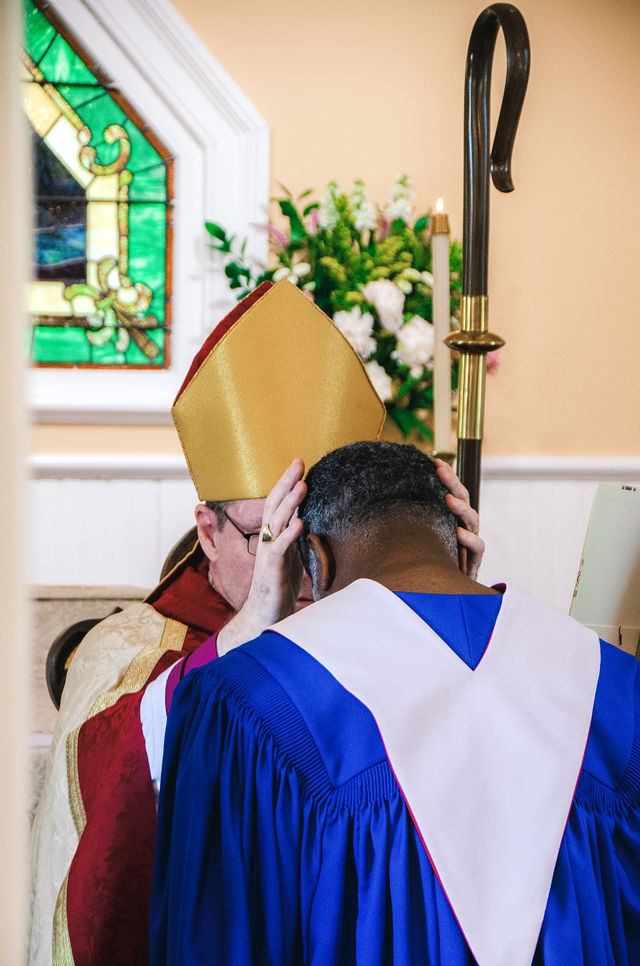 Bishop Stevenson lays hands in prayer during the Grace Episcopal Church anniversary service.