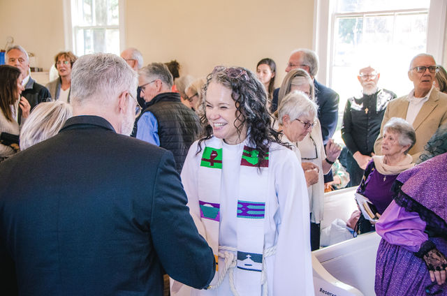 Members of Grace Episcopal Church greet one another during the anniversary celebration.
